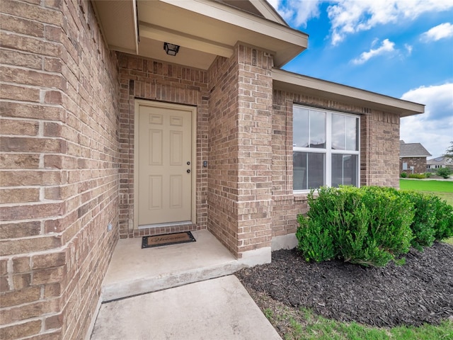 7632 Lombardy Loop, Round Rock, TX 78665 - doorway to property featuring brick siding