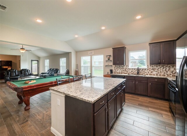 7632 Lombardy Loop, Round Rock, TX 78665 - kitchen featuring dark wood-style floors, dark brown cabinets, a sink, lofted ceiling, and plenty of natural light