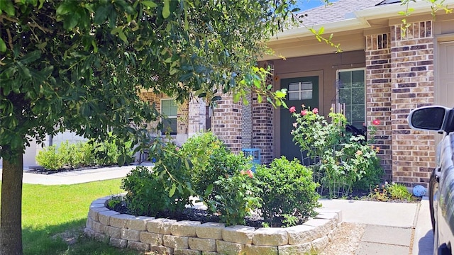 221 Tributary Way, Bastrop, TX 78602 - doorway to property with brick siding and a shingled roof