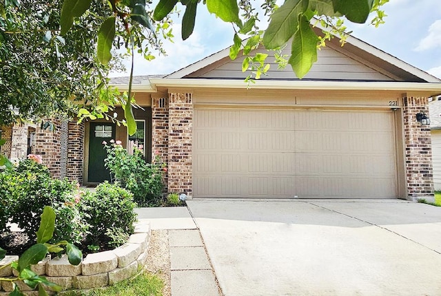 221 Tributary Way, Bastrop, TX 78602 - view of front facade featuring brick siding, a garage, and concrete driveway