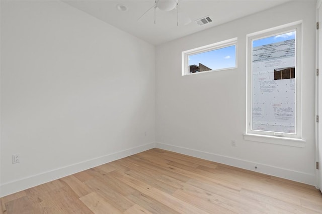 900 S 2nd St Unit 21, Austin, TX 78704 - unfurnished room with light wood-type flooring, baseboards, and healthy amount of natural light