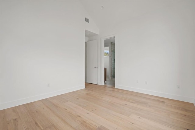 900 S 2nd St Unit 21, Austin, TX 78704 - unfurnished room with baseboards, light wood-type flooring, and lofted ceiling