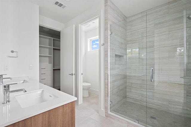 900 S 2nd St Unit 21, Austin, TX 78704 - bathroom featuring toilet, a stall shower, double vanity, and tile patterned flooring