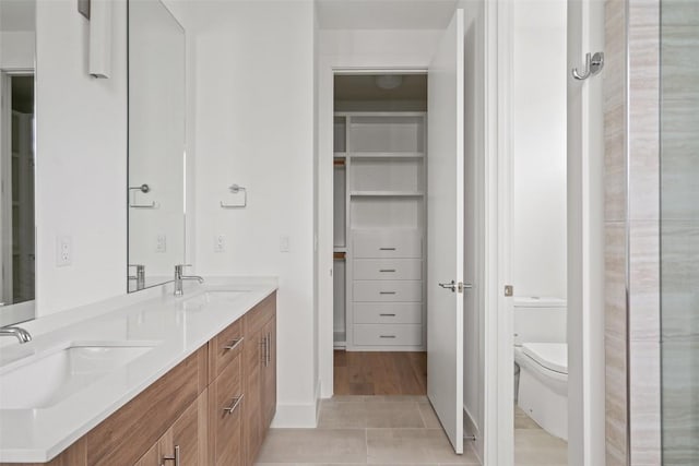 900 S 2nd St Unit 21, Austin, TX 78704 - full bathroom featuring toilet, double vanity, and tile patterned flooring