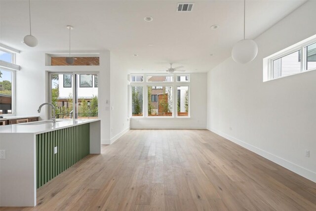 900 S 2nd St Unit 21, Austin, TX 78704 - unfurnished living room with a sink, healthy amount of natural light, and light wood finished floors
