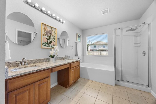 805 Meadow Bluff Ct, Round Rock, TX 78665 - bathroom featuring a shower stall, a garden tub, double vanity, and tile patterned floors