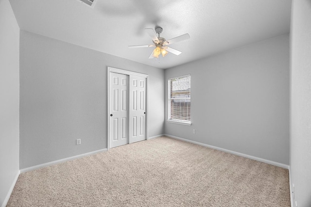 805 Meadow Bluff Ct, Round Rock, TX 78665 - unfurnished bedroom featuring carpet floors, a closet, baseboards, and a ceiling fan