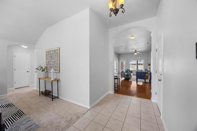 805 Meadow Bluff Ct, Round Rock, TX 78665 - hall featuring arched walkways, light tile patterned flooring, baseboards, and lofted ceiling
