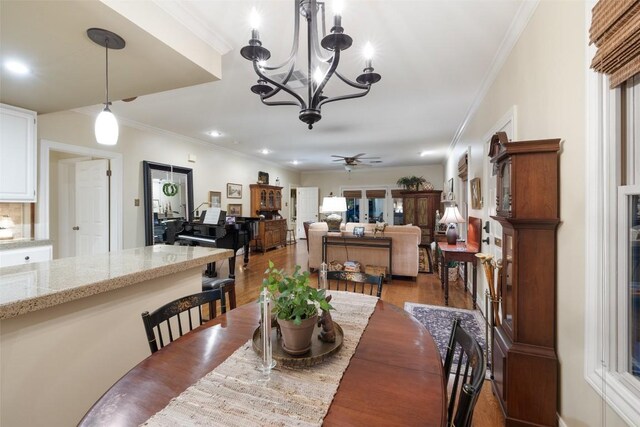 40 Tournament Way Unit G-32, The Hills, TX 78738 - dining space with ceiling fan, wood finished floors, ornamental molding, a chandelier, and recessed lighting
