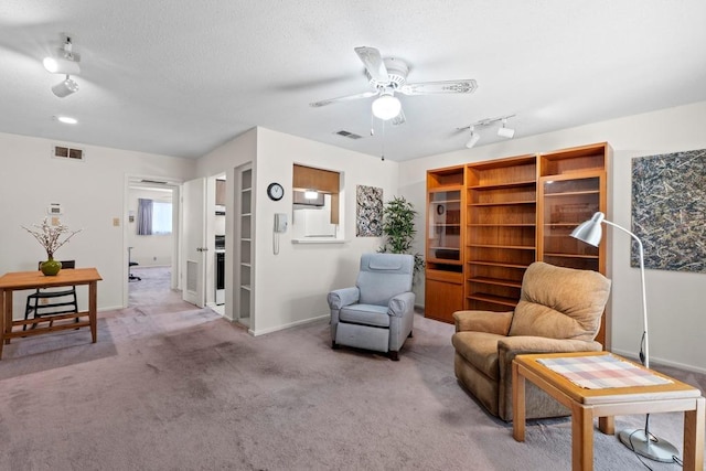 7920 Rockwood Ln Unit 232, Austin, TX 78757 - sitting room featuring ceiling fan, carpet, and baseboards