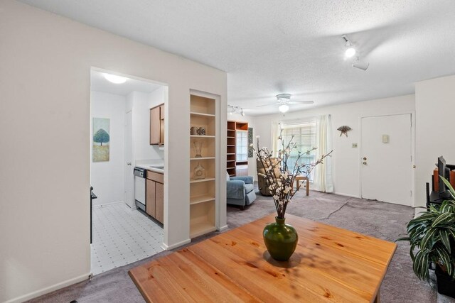 7920 Rockwood Ln Unit 232, Austin, TX 78757 - dining area featuring light carpet, a textured ceiling, a ceiling fan, and built in features