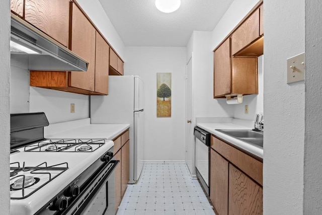 7920 Rockwood Ln Unit 232, Austin, TX 78757 - kitchen with gas stove, under cabinet range hood, dishwashing machine, light floors, and light countertops