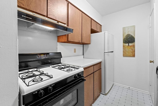 7920 Rockwood Ln Unit 232, Austin, TX 78757 - kitchen featuring black range with gas stovetop, under cabinet range hood, brown cabinetry, and light countertops