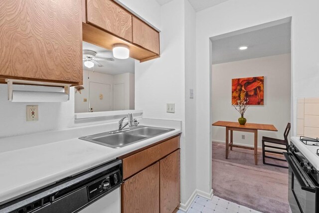 7920 Rockwood Ln Unit 232, Austin, TX 78757 - kitchen featuring white dishwasher, gas range, light countertops, a ceiling fan, and light colored carpet