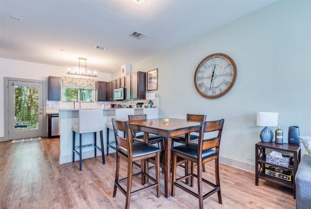12160 Abbey Glen Ln, Austin, TX 78753 - dining space featuring light wood-style flooring and a chandelier