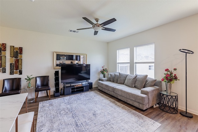 301 Wonderful Life Way, Jarrell, TX 76537 - living area with a ceiling fan, wood finished floors, and baseboards