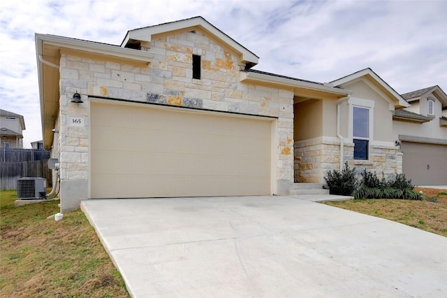 365 Victoria Peak Loop, Dripping Springs, TX 78620 - view of front of home featuring stone siding, cooling unit, concrete driveway, stucco siding, and an attached garage