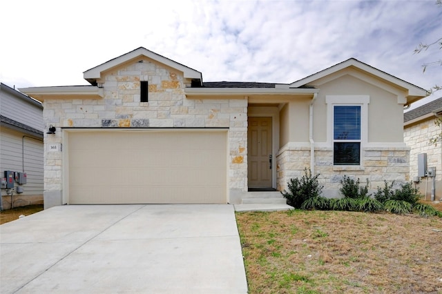 365 Victoria Peak Loop, Dripping Springs, TX 78620 - view of front of property with stone siding, an attached garage, driveway, and stucco siding