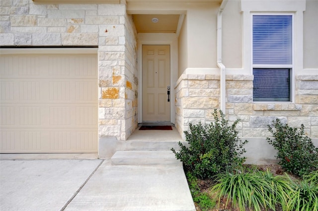 365 Victoria Peak Loop, Dripping Springs, TX 78620 - doorway to property featuring a garage, stone siding, and stucco siding