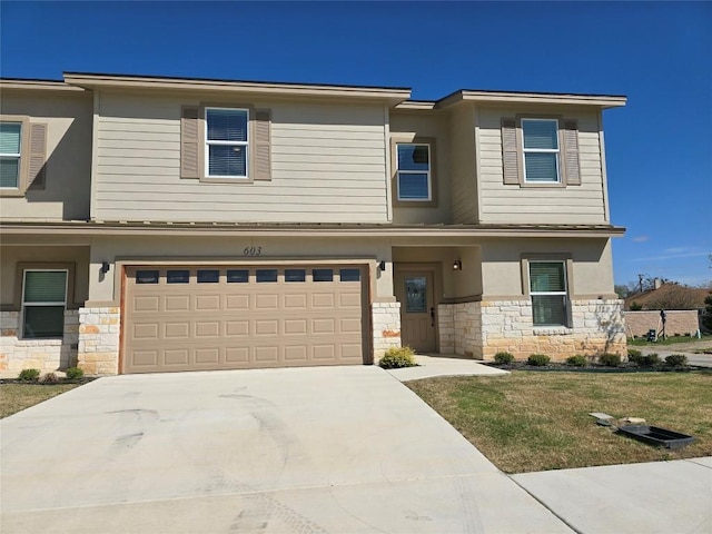 2105 Tiger Trl Unit 603, Round Rock, TX 78665 - prairie-style house with stone siding, an attached garage, concrete driveway, and stucco siding