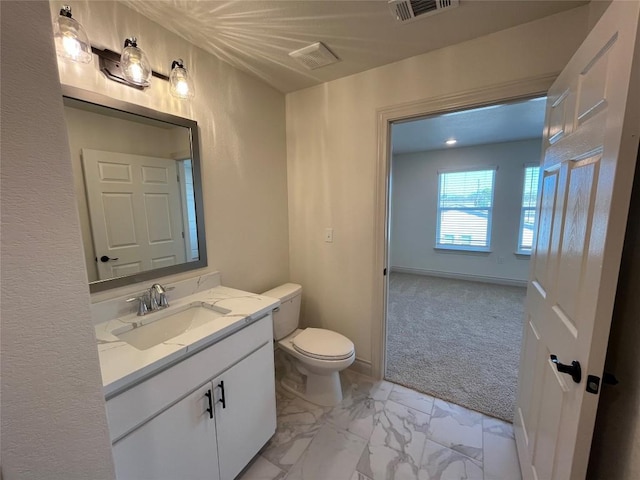 2105 Tiger Trl Unit 603, Round Rock, TX 78665 - half bathroom featuring marble look tiles, vanity, and toilet