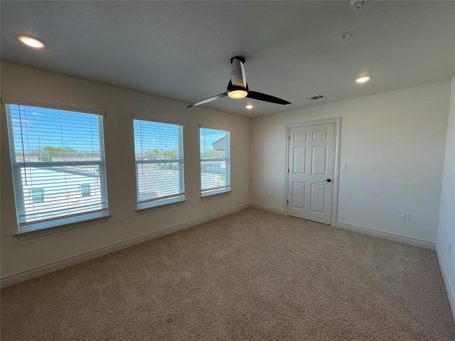 2105 Tiger Trl Unit 603, Round Rock, TX 78665 - spare room with plenty of natural light, light carpet, baseboards, a ceiling fan, and recessed lighting