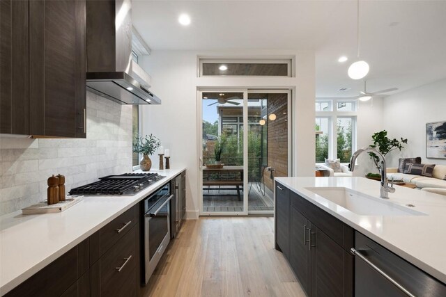 900 S 2nd St Unit 20, Austin, TX 78704 - kitchen featuring a ceiling fan, appliances with stainless steel finishes, a sink, range hood, and light countertops
