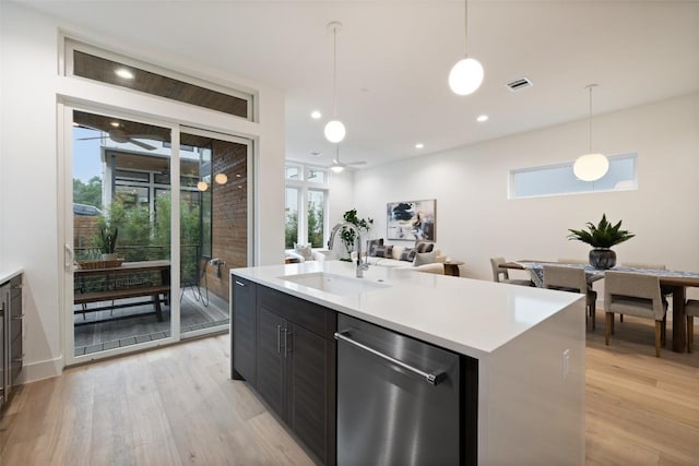 900 S 2nd St Unit 20, Austin, TX 78704 - kitchen with dishwasher, a sink, light wood finished floors, light countertops, and decorative light fixtures