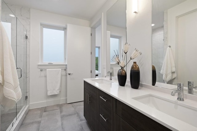 900 S 2nd St Unit 20, Austin, TX 78704 - full bathroom featuring double vanity, a stall shower, and baseboards
