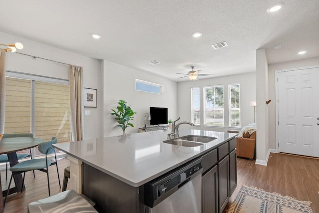 8012 Mandela Bnd, Austin, TX 78744 - kitchen with dishwasher, a sink, open floor plan, wood finished floors, and recessed lighting