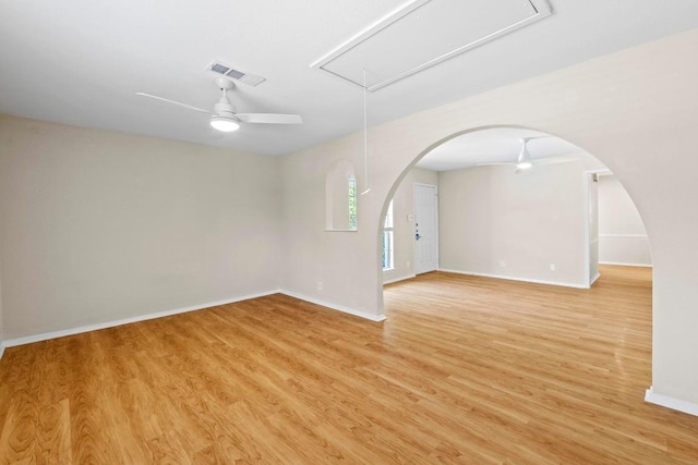 3103 Steck Ave, Austin, TX 78757 - empty room featuring attic access, ceiling fan, light wood-type flooring, baseboards, and arched walkways