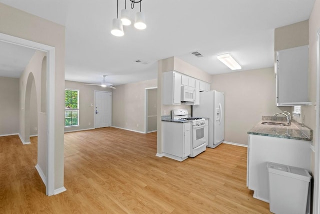 3103 Steck Ave, Austin, TX 78757 - kitchen featuring white appliances, a sink, light wood finished floors, and baseboards