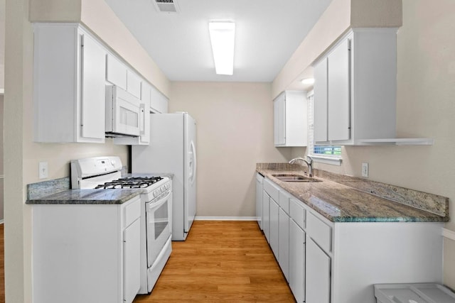 3103 Steck Ave, Austin, TX 78757 - kitchen with a sink, white appliances, light wood-type flooring, white cabinetry, and baseboards