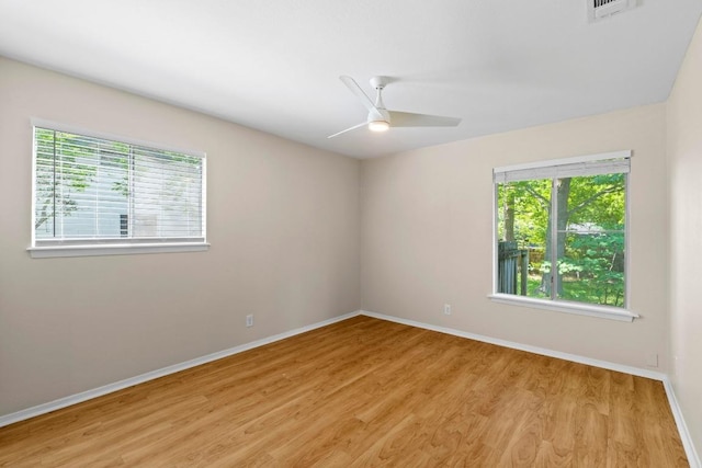 3103 Steck Ave, Austin, TX 78757 - spare room with healthy amount of natural light, light wood-style flooring, and baseboards