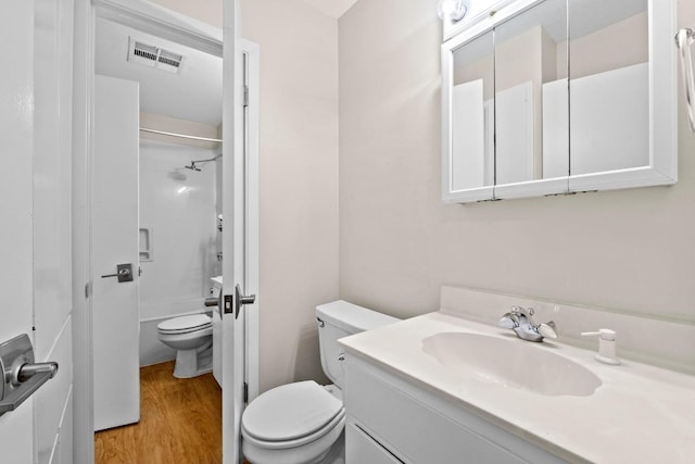 3103 Steck Ave, Austin, TX 78757 - bathroom featuring toilet, vanity, wood finished floors, and shower / bath combination