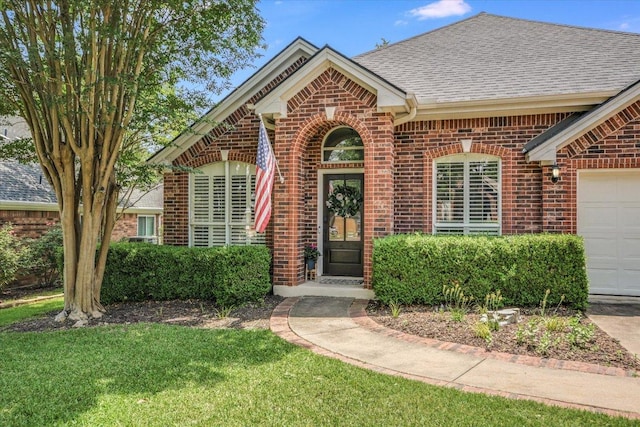 10807 Pinkney Ln, Austin, TX 78739 - view of front of home with brick siding, a shingled roof, an attached garage, and a front yard