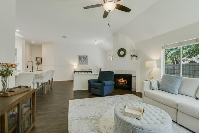 10807 Pinkney Ln, Austin, TX 78739 - living area featuring dark wood-type flooring, a tile fireplace, ceiling fan, lofted ceiling, and recessed lighting