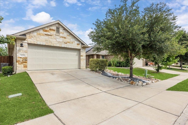 3620 Breckenridge Dr, Austin, TX 78744 - view of front facade featuring stone siding, driveway, a front yard, an attached garage, and central AC unit
