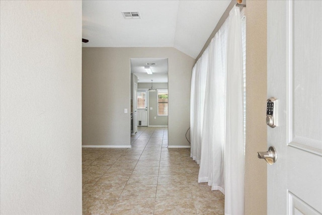 3620 Breckenridge Dr, Austin, TX 78744 - corridor with vaulted ceiling, light tile patterned flooring, and baseboards
