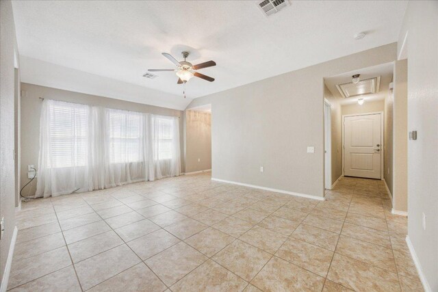 3620 Breckenridge Dr, Austin, TX 78744 - unfurnished room featuring a ceiling fan, attic access, light tile patterned floors, and baseboards