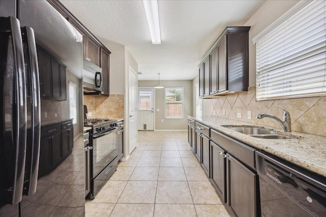 3620 Breckenridge Dr, Austin, TX 78744 - kitchen featuring black appliances, a sink, decorative backsplash, light stone counters, and dark brown cabinetry