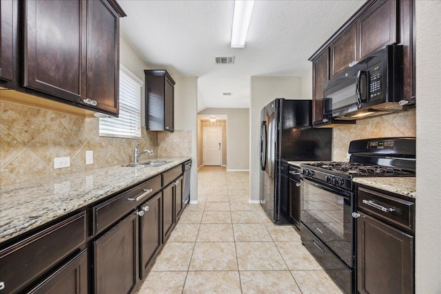 3620 Breckenridge Dr, Austin, TX 78744 - kitchen featuring black appliances, dark brown cabinets, a sink, backsplash, and a textured ceiling