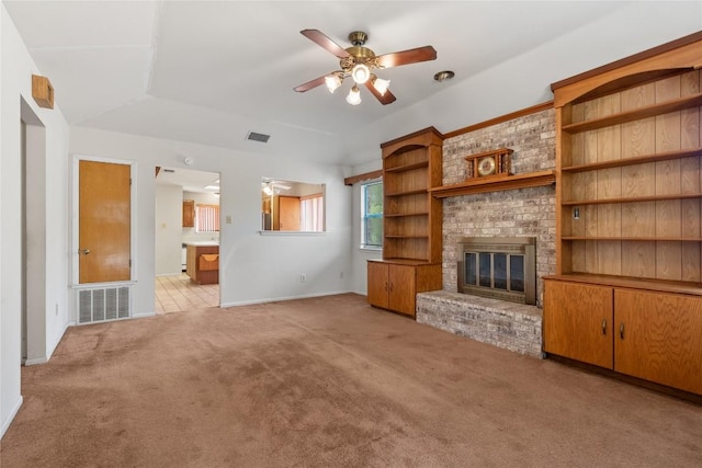 356 Cedar Ln, Cedar Creek, TX 78612 - unfurnished living room with light carpet, ceiling fan, and a brick fireplace