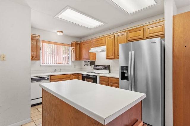 356 Cedar Ln, Cedar Creek, TX 78612 - kitchen with white appliances, under cabinet range hood, light countertops, and light tile patterned flooring