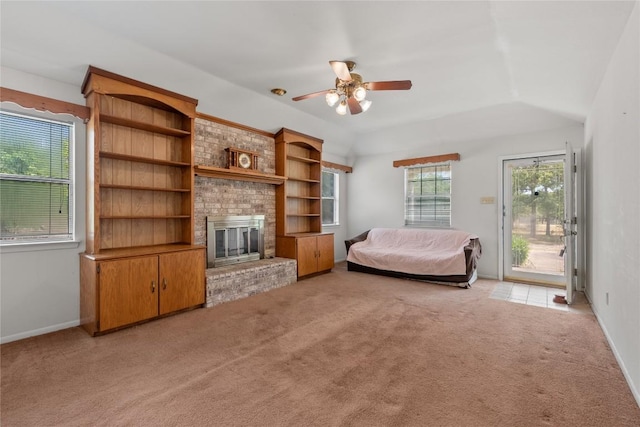 356 Cedar Ln, Cedar Creek, TX 78612 - living room with plenty of natural light, light carpet, ceiling fan, a fireplace, and vaulted ceiling
