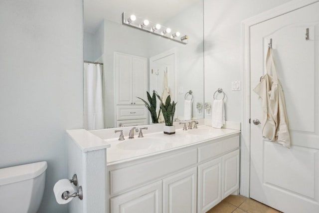 2302 Bahama Rd, Austin, TX 78733 - bathroom with toilet, double vanity, and tile patterned flooring