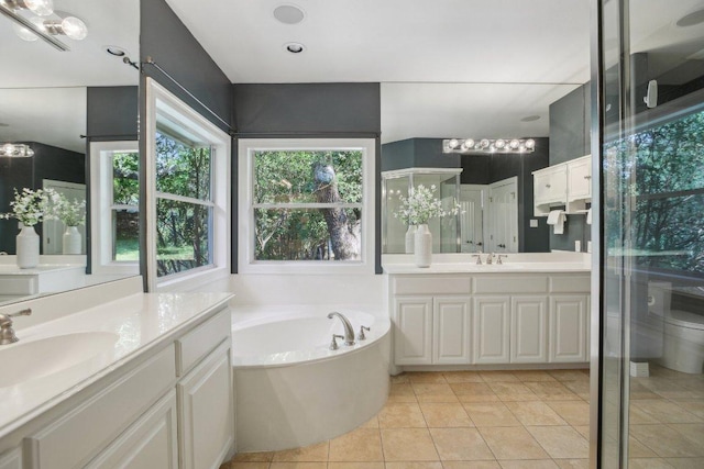 2302 Bahama Rd, Austin, TX 78733 - bathroom with two vanities, a garden tub, tile patterned floors, toilet, and a stall shower