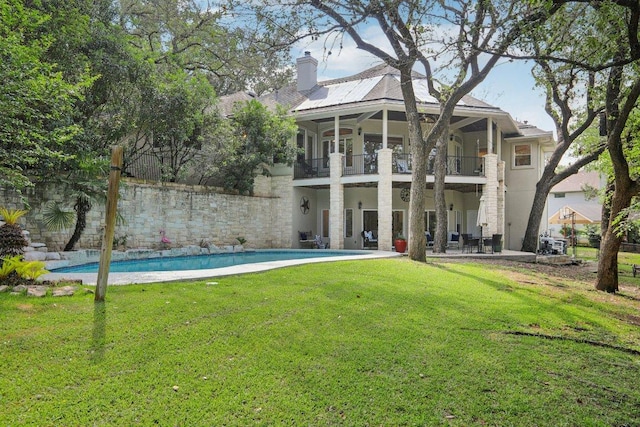 2302 Bahama Rd, Austin, TX 78733 - back of property featuring a balcony, a lawn, stucco siding, a patio, and a chimney