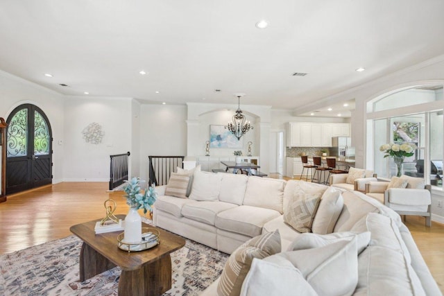 2302 Bahama Rd, Austin, TX 78733 - living room featuring a chandelier, light wood-style flooring, recessed lighting, ornamental molding, and baseboards