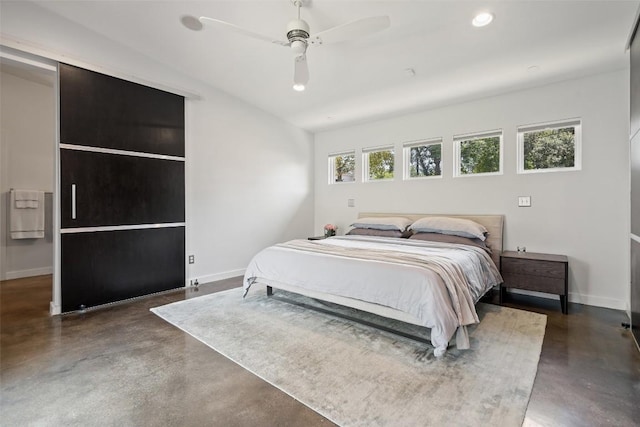7517 Saint Louis St, Austin, TX 78757 - bedroom with finished concrete flooring, baseboards, a ceiling fan, recessed lighting, and vaulted ceiling